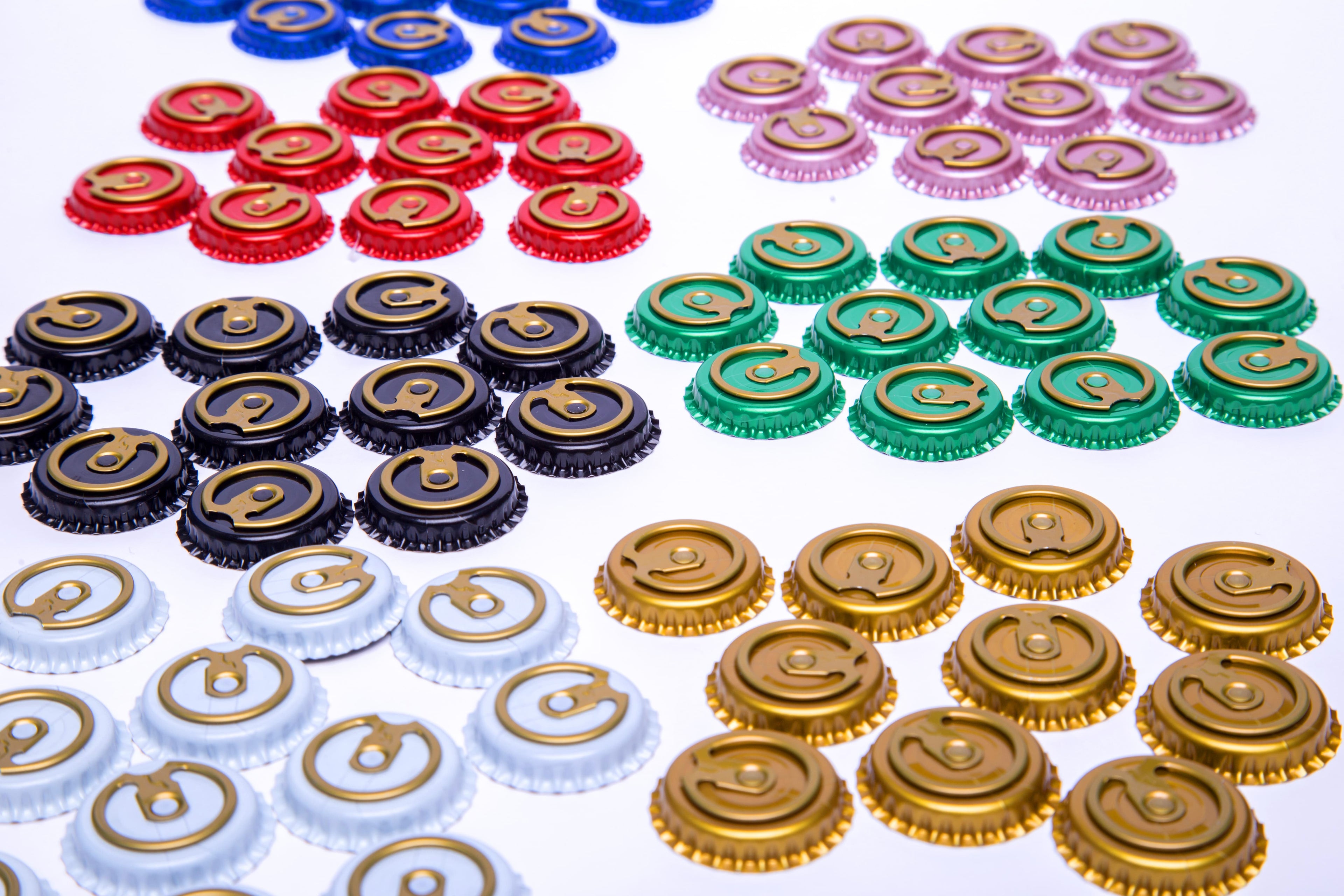 Colorful bottle caps, Easy-Open, TSOLEBOURG, 26mm, arranged in rows on a white background. Buy wholesale
